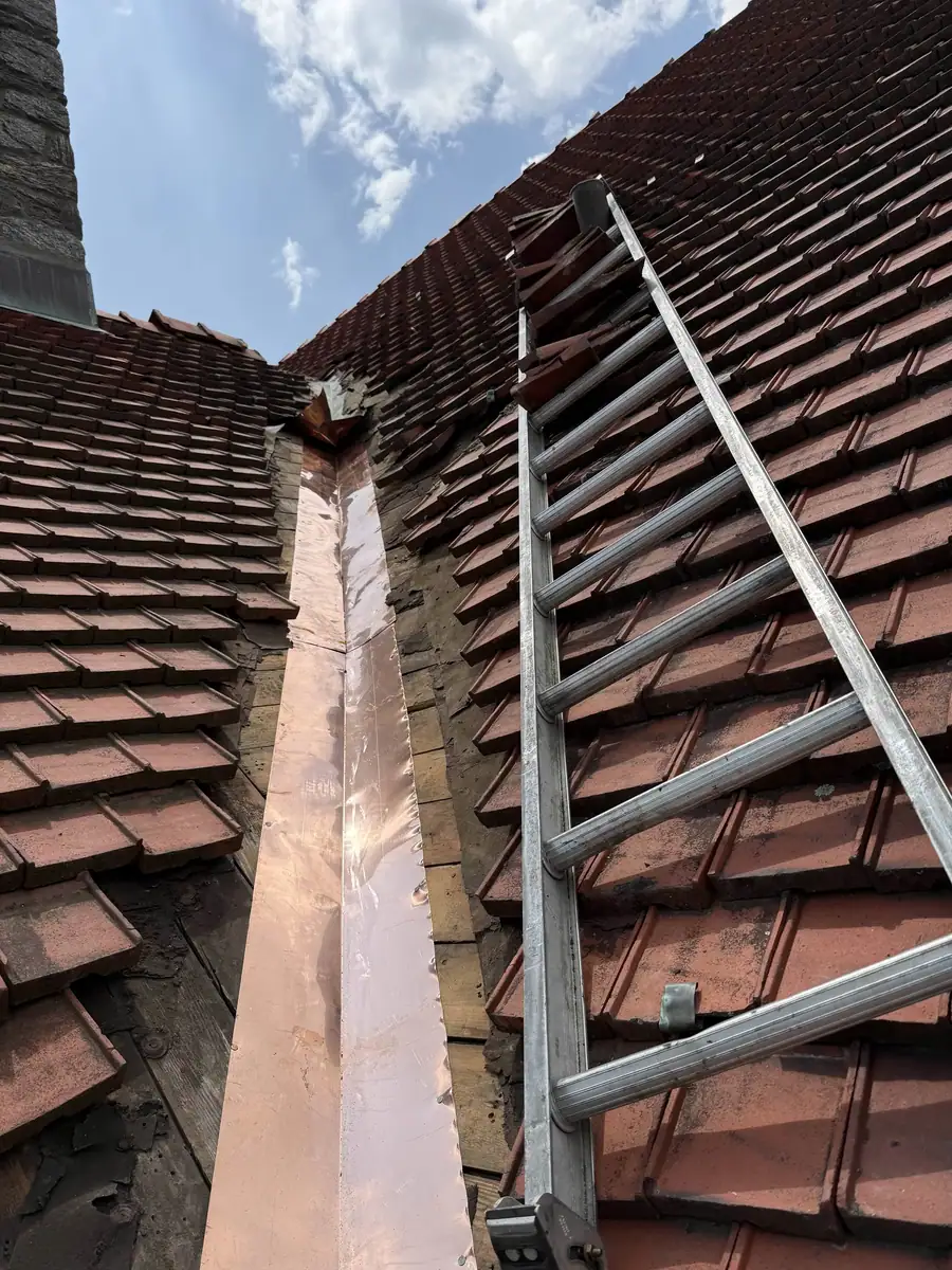 Copper valley flashing being formed between tile roof slopes