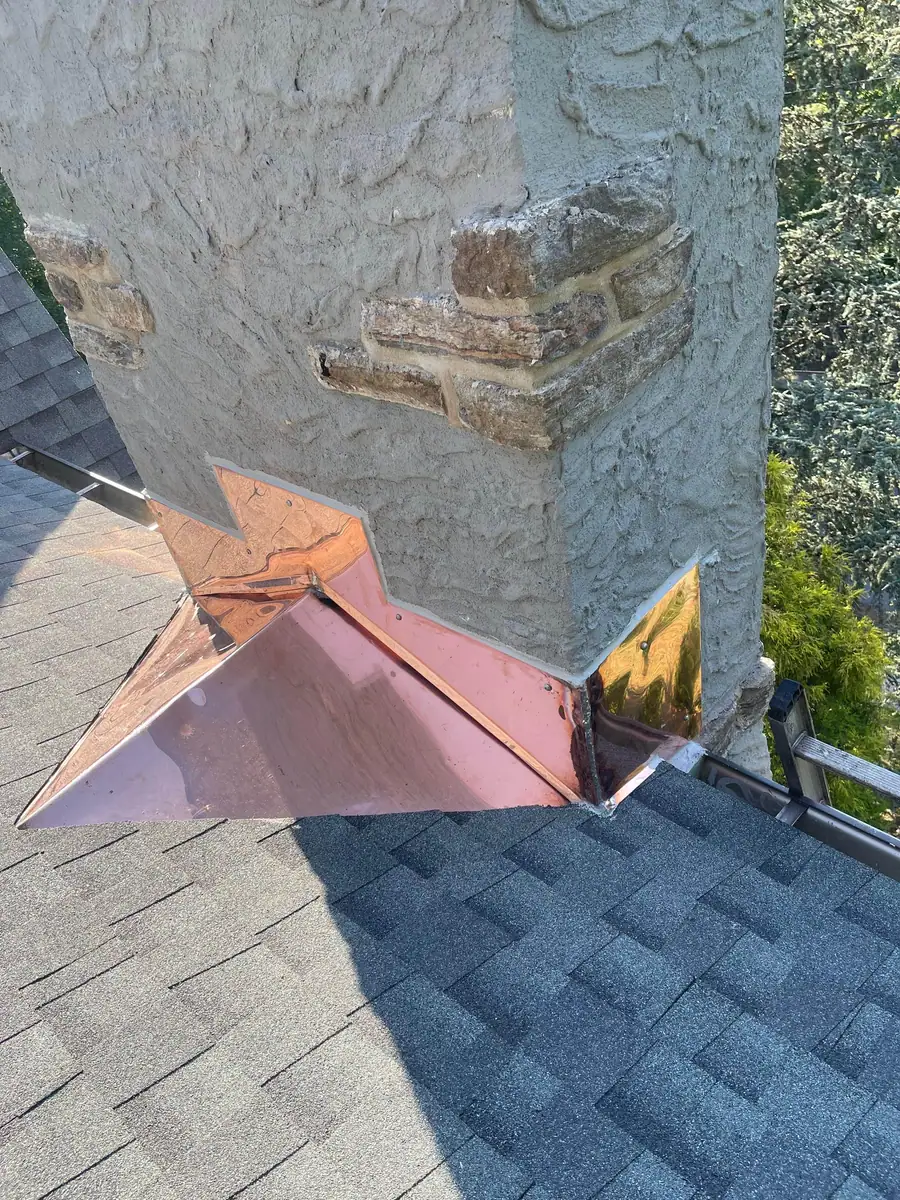 Finished copper flashing and chimney cricket detail